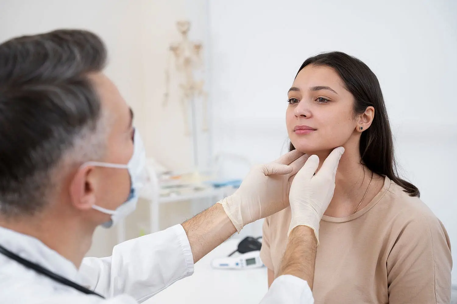 At Smile City Orthodontics in Sunnyvale TX, a doctor wearing gloves examines a young woman's neck during a clinical check-up, possibly evaluating her for jaw surgery.