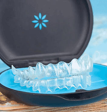 Perfect for those on an Invisalign payment plan, Smile City Orthodontics in Sunnyvale, TX offers clear dental aligners in a stylish blue and black floral carrying case.