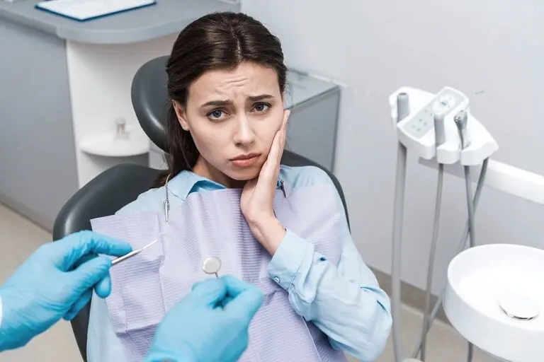 selective focus dentist latex gloves holding dental instruments upset woman - TMJ Treatment in Sunnyvale, TX