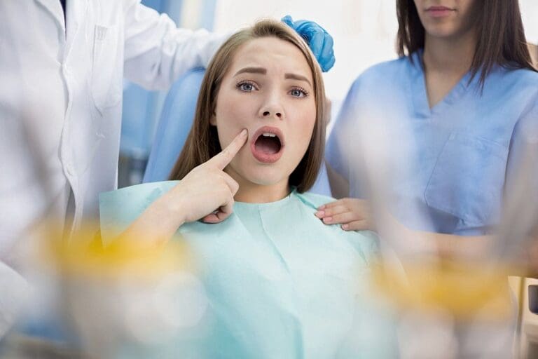 girl in dental ambulance show sore spot - overbite vs underbite in Sunnyvale, TX.